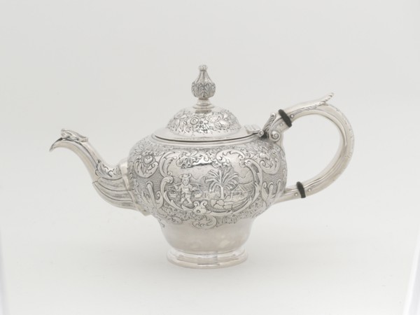 Teapot, 1848. Repoussé decoration, man carrying a yoke laden with baskets of produce.