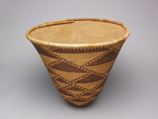 Burden Basket, 1870/80. Large tan woven basket with dark brown triangles.