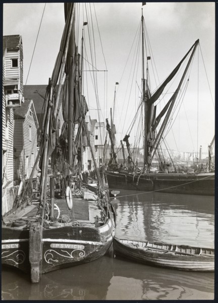 Sailed fishing vessels moored beside timber warehouses at Rochester, Medway, 1925-1935. Creator: J Dixon Scott.