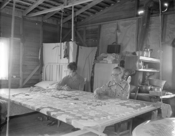Grandmother from Oklahoma with grandson, working on quilt, California, Kern County, 1936. Creator: Dorothea Lange.