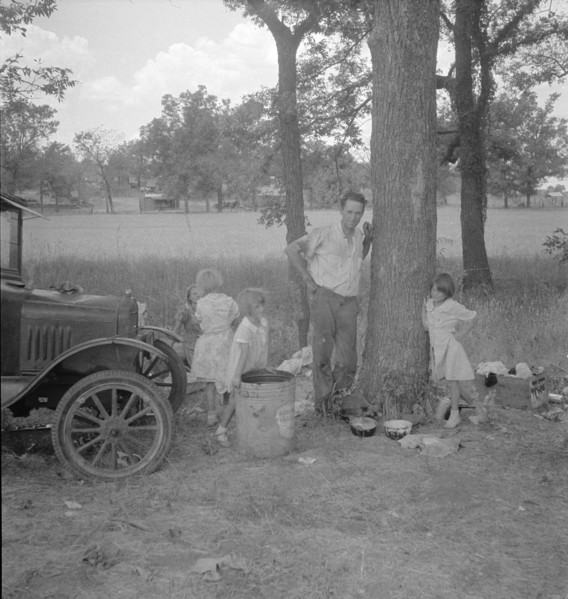 Migrant family from Oklahoma in Texas, alongside the road, 1936. Creator: Dorothea Lange.
