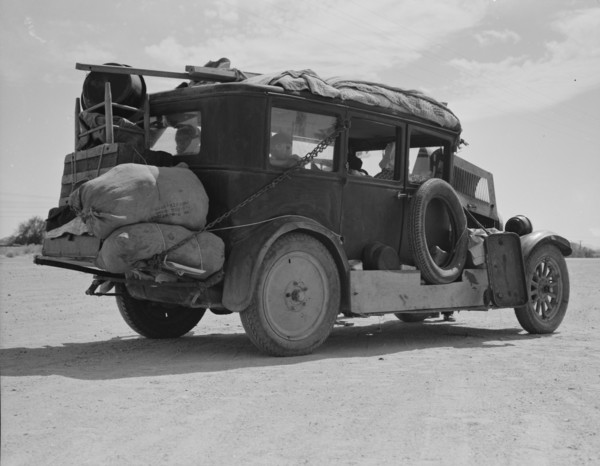 Family...from Fort Smith, Arkansas, trying to repair their car..., Arizona, 1937. Creator: Dorothea Lange.