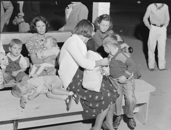 At the end of the Halloween party at Shafter migrant camp, California, 1938. Creator: Dorothea Lange.