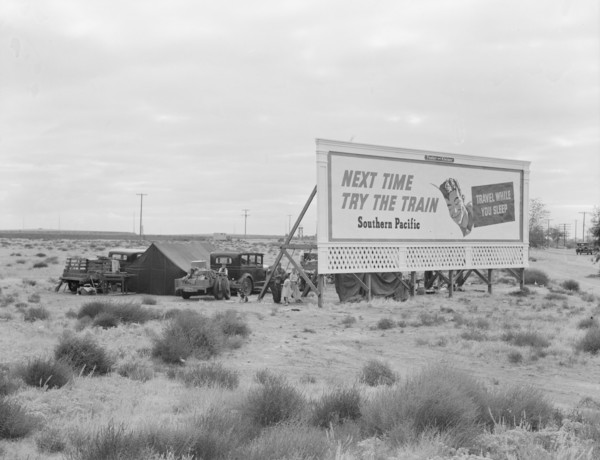 Billboard along U.S. 99...three destitute families...Kern County, CA, 1938. Creator: Dorothea Lange.