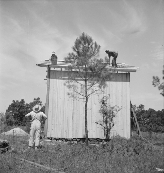 Building plank tobacco barn to replace old log one, near Chapel Hill, North Carolina, 1939 Creator: Dorothea Lange.