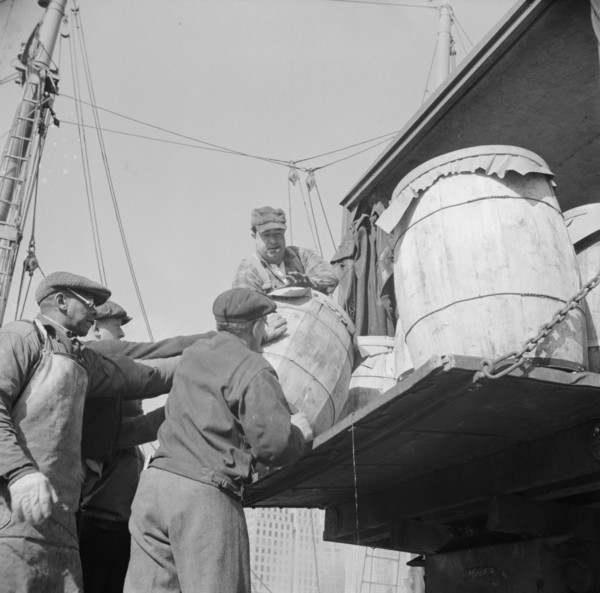 Dock worker at the Fulton fish market loading fish that have been caught..., New York, 1943. Creator: Gordon Parks.