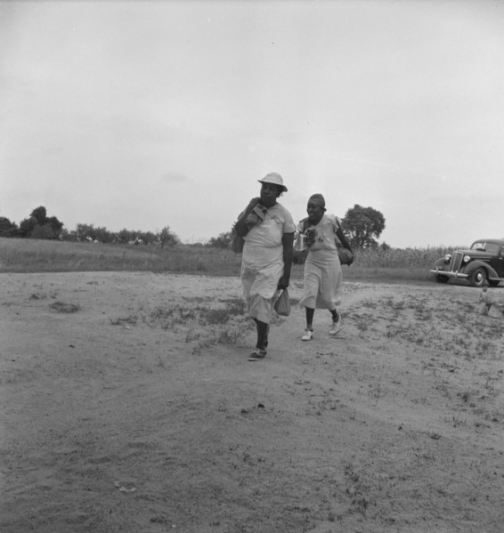 Mother of sharecropper family and friend...in the rain, Person County, North Carolina, 1939. Creator: Dorothea Lange.
