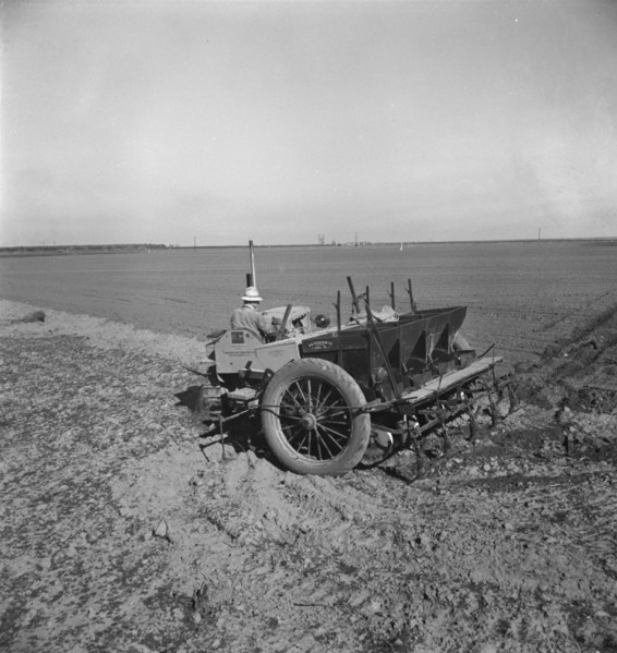 Large-scale, mechanized farming - potato planter, Kern County, California, 1939. Creator: Dorothea Lange.