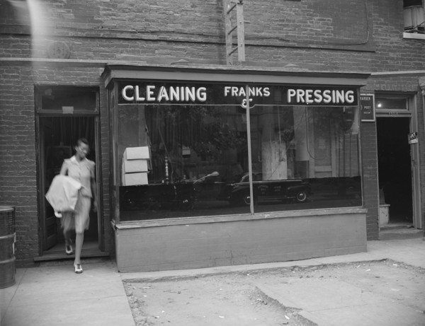 Possibly: A tailor in Frank's cleaning and pressing establishment checking..., Washington, DC, 1942. Creator: Gordon Parks.