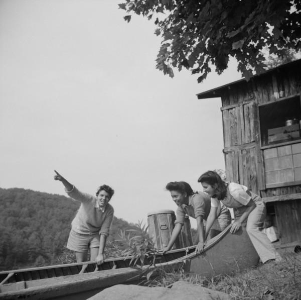 Launching a canoe at Camp Gaylord White, Arden, New York, 1943. Creator: Gordon Parks.