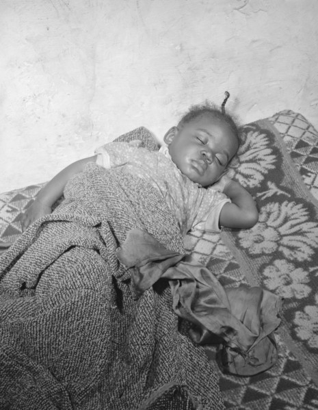 Child seriously ill from an infection caused by a rat bite in her home..., Washington, D.C., 1942. Creator: Gordon Parks.