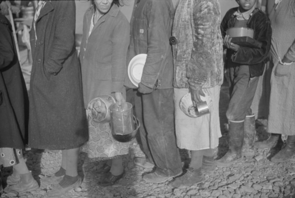 Possibly: Negroes at mealtime in the flood refugee camp, Forrest City, Arkansas, 1937. Creator: Walker Evans.