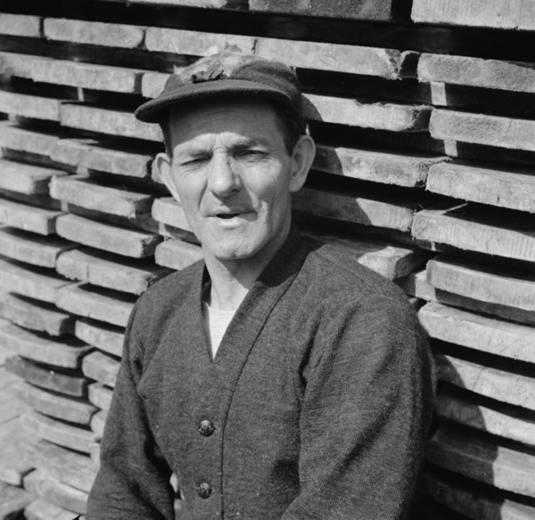 New England fisherman resting at the New York docks after unloading his cargo of fish, 1943. Creator: Gordon Parks.