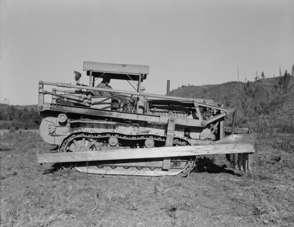 Western Washington, Lewis County. Caterpillar clearing land on cut-over western Washington farm.