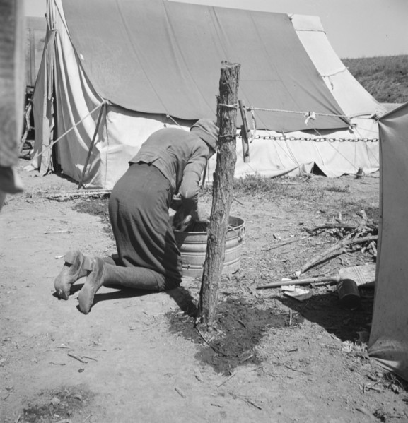 A grandmother washing clothes in California. In a contractor's camp near Westley, California.