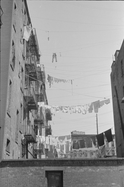New York, New York. 61st Street between 1st and 3rd Avenues. Apartment houses from the rear.