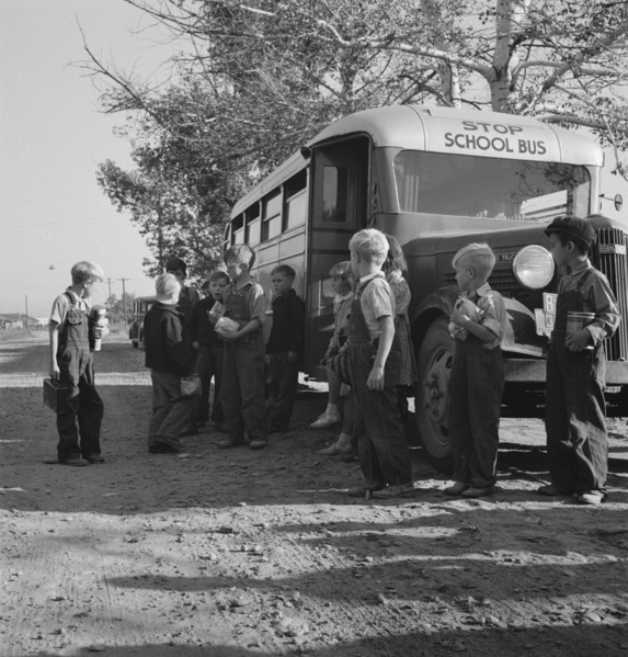 The children from Dead Ox Flat get off bus at school yard. Ontario, Malheur County, Oregon.