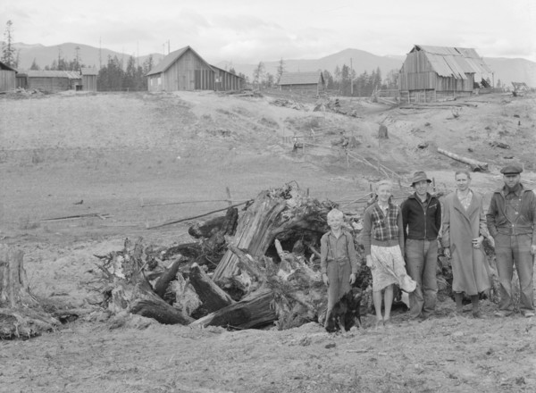 The Unruf family, stump pile, and their partly developed farm. Boundary County, Idaho.