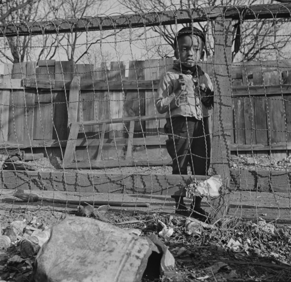 Washington (southwest section), D.C. Boy playing in the backyard of his home.