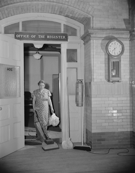 Washington, D.C. Government charwoman cleaning after regular hours.