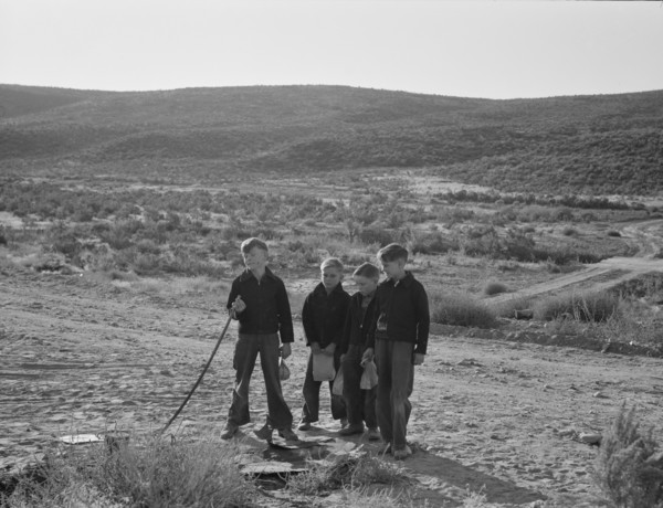 Boys wait for school bus in the morning. Malheur County, Oregon.