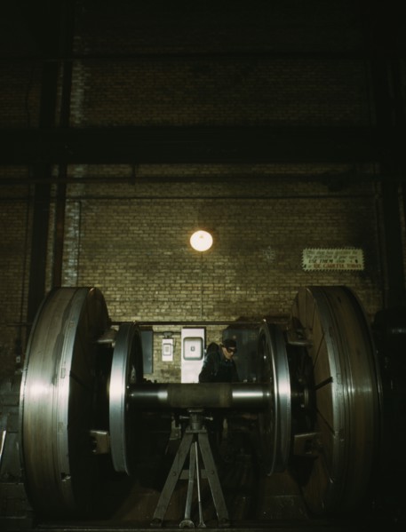 Worn tires on locomotive wheels are refaced on this machine in the wheel shop..., Chicago, 1942. Creator: Jack Delano.