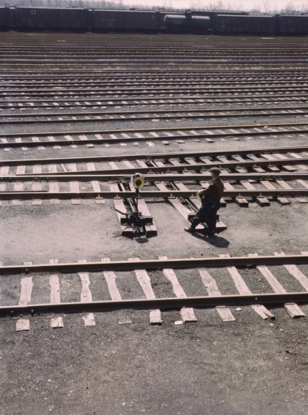 Switchman throwing a switch a C and NW RR's Proviso yard, Chicago, Ill., 1943. Creator: Jack Delano.