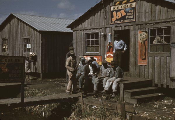 Migratory laborers outside of a "juke joint" during a slack season, Belle Glade, Fla., 1941. Creator: Marion Post Wolcott.