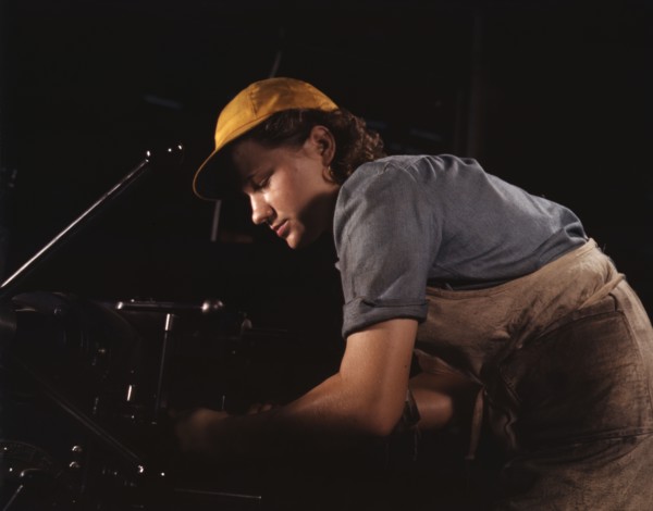 A lathe operator machining parts for...Consolidated Aircraft Corp. plant, Fort Worth, Texas, 1942. Creator: Howard Hollem.