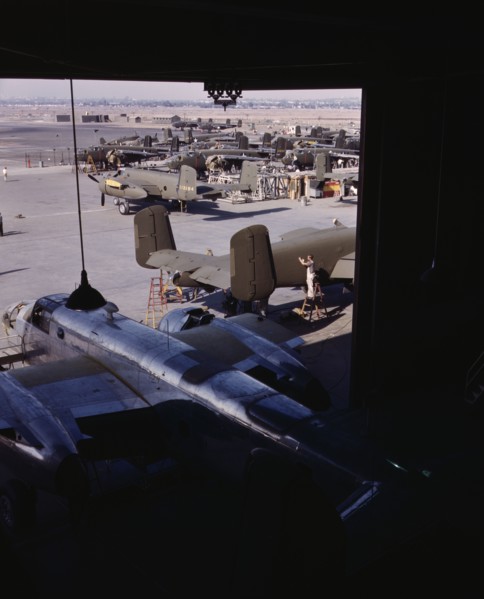 Another North American B-25 bomber rolls off the final assembly line to join other ships..., 1942. Creator: Alfred T Palmer.