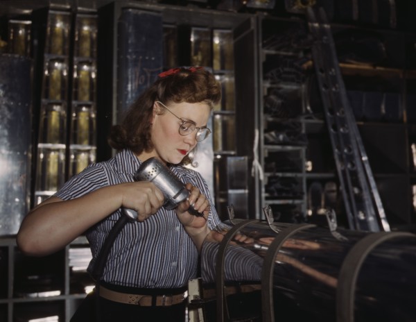 Operating a hand drill at the North American Aviation, Inc., a woman is in the control..., 1942. Creator: Alfred T Palmer.