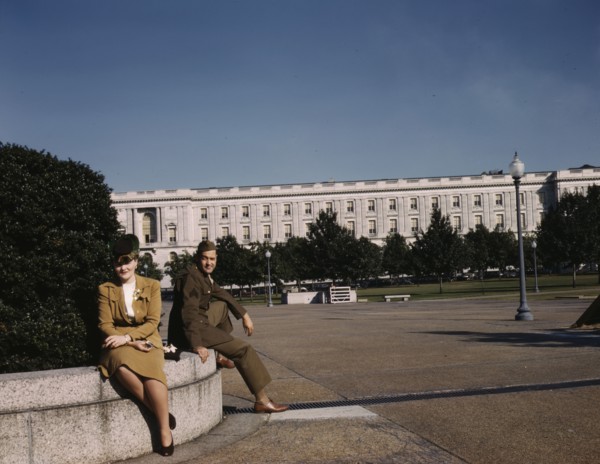 A soldier and a woman in a park, with the Old Russell Senate Office..., Washington, D.C., ca. 1943. Creator: Unknown.