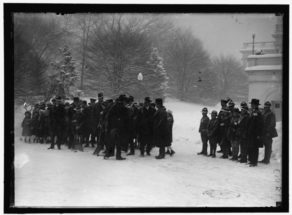 Group outside White House in snow, between 1913 and 1918.