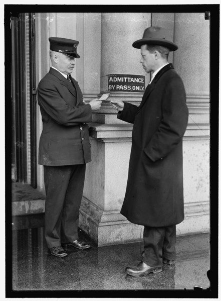 Examining pass at State Department Building, between 1913 and 1918. Creator: Harris & Ewing.