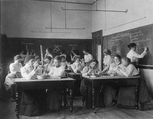 Group of young women performing atmospheric pressure experiments while studying..., (1899?). Creator: Frances Benjamin Johnston.
