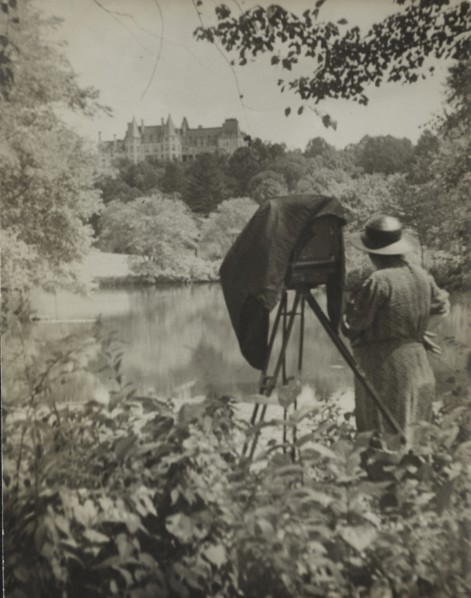 Photographer Frances Benjamin Johnston standing beside her large view camera looking..., c1938. Creator: Unknown.