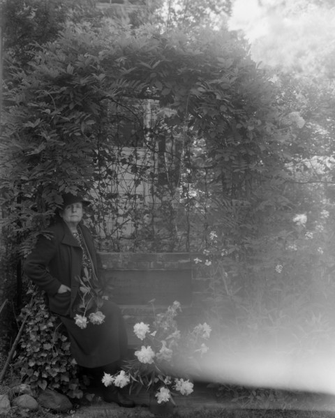 Frances Benjamin Johnston, photographer, posed sitting with peonies..., Takoma Park, Maryland, 1938. Creator: Unknown.