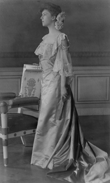 Alice Roosevelt Longworth, full-length portrait, standing next to chair, facing left, 1903. Creator: Frances Benjamin Johnston.
