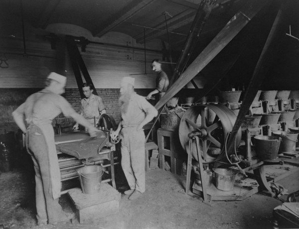 Workers grinding and processing the ink used to print paper money at the Bureau of Engrav..., c1890. Creator: Frances Benjamin Johnston.
