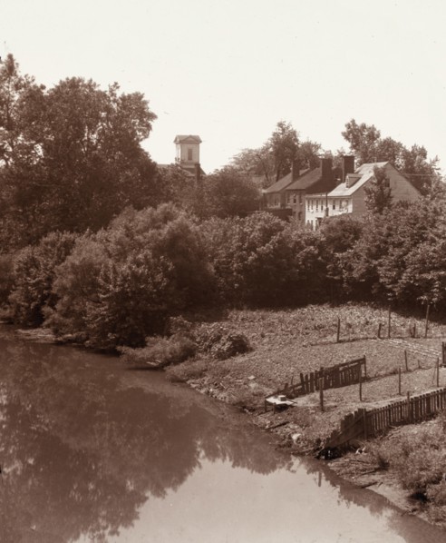 Houses on Water Street, from the bridge, Fredericksburg, Virginia, between 1927 and 1929. Creator: Frances Benjamin Johnston.