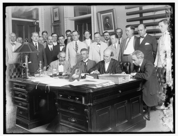 Group: includes William Jennings Bryan (at desk, 2nd from right)..., between 1910 and 1920. Creator: Harris & Ewing.