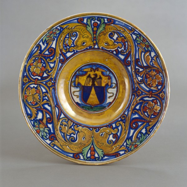 Plate with border of foliate scrollwork with dolphin heads and cornucopias; in the center..., 1524. Creator: Giorgio Andreoli workshop.