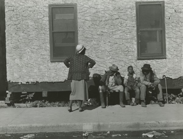 Two African American men and one African American boy sitting and one African..., Jan 1939. Creators: Farm Security Administration, Marion Post Wolcott.