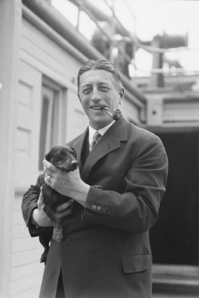 Von Lueckner, Felix, Count, with dog, standing outdoors, 1931 June 5. Creator: Arnold Genthe.