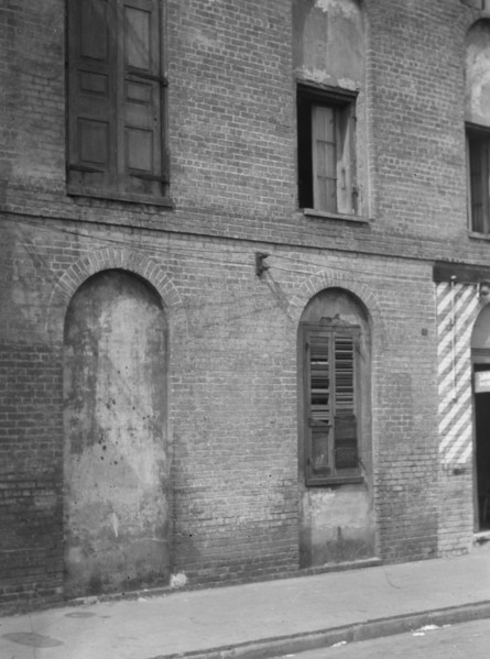 Facade of a multi-story building, New Orleans or Charleston, South Carolina, between 1920 and 1926. Creator: Arnold Genthe.