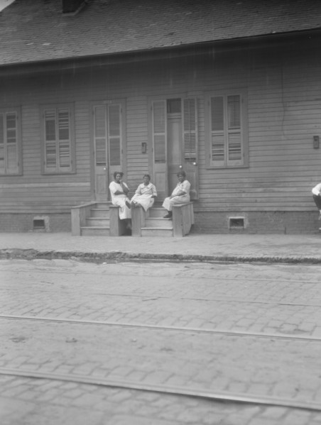 View from across street of three women talking, New Orleans or Charleston, South Ca., c1920-c1926. Creator: Arnold Genthe.