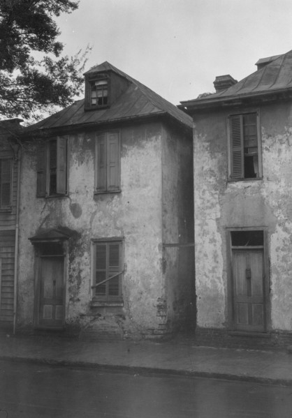 Facades of two-story houses, [Alexander Peronneau Tenements, 141 Church Street..., c1920-1926. Creator: Arnold Genthe.