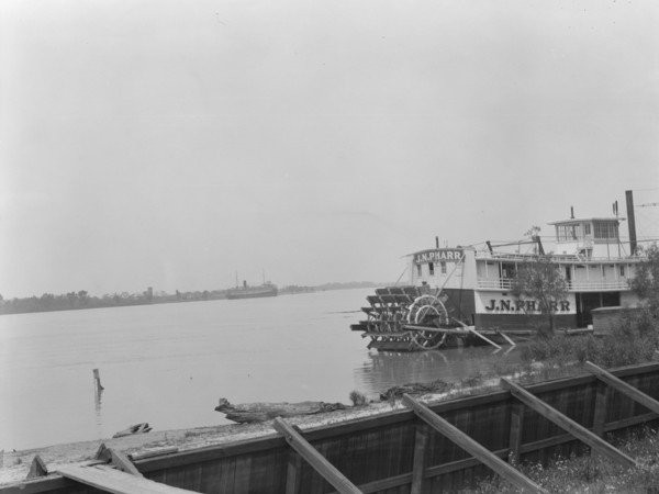 Paddle wheel steamboat on river, New Orleans, between 1920 and 1926. Creator: Arnold Genthe.