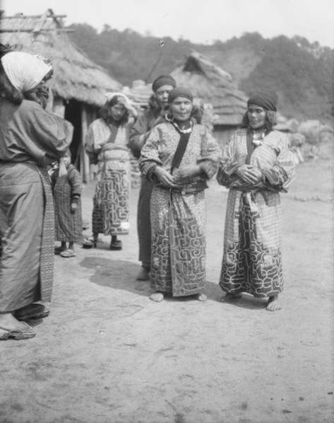 Ainu woman outside in the village lane, 1908. Creator: Arnold Genthe.