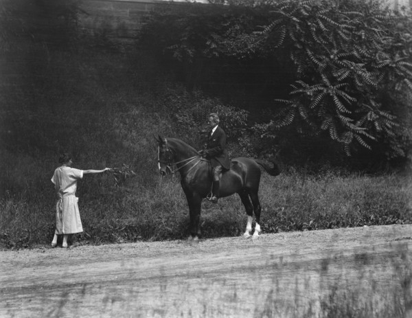 Arnold Genthe riding Chesty, between 1911 and 1936. Creator: Arnold Genthe.